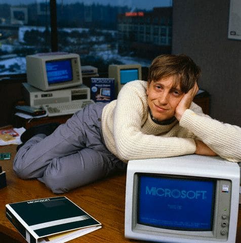 Bill Gates reclining on desk